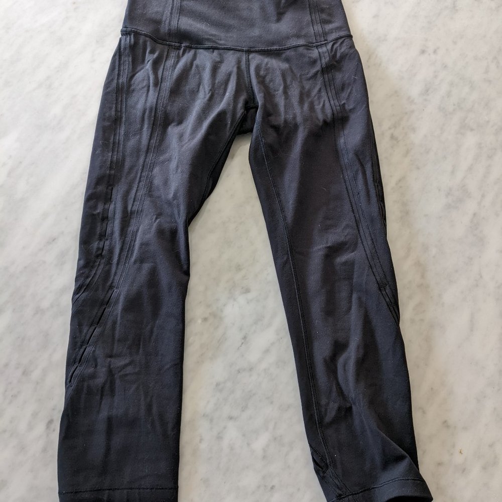 Lululemon 21" Black Leggings with slight cutouts down legs